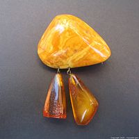 Front view showing mottled amber top and two cognac amber dangles