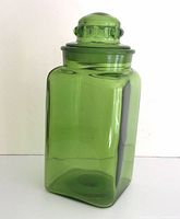 Front view of green glass cookie jar with lid on
