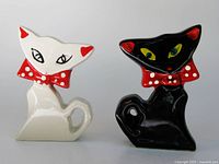 Front view of both cat shakers showing faces and bow ties