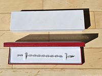 Bracelet in open red presentation box with white outer box