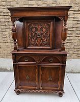 Front view showing full cabinet proportions and carvings