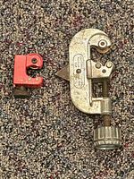 Both pipe cutters side by side on carpet