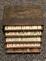 Front view of rosewood case with drawers partially open showing bone & bamboo tiles