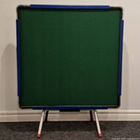 Front view of mahjong table on legs showing green surface and blue edge