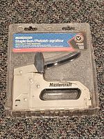 Front view of sealed Mastercraft staple gun in packaging
