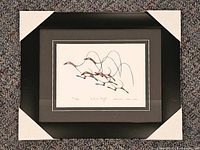 Front view of framed print with protective corner covers showing artwork and matting