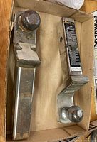 Two aluminum hitch mounts with 2 in balls in box