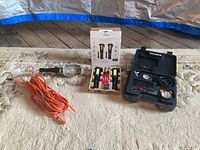 All items overview on rug: shop light, Infinity lights box, compressor case