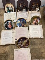 All seven plates displayed with boxes and certificates