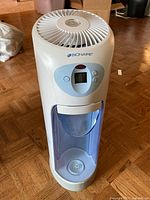 Humidifier front view showing digital panel, blue tank, and top vent