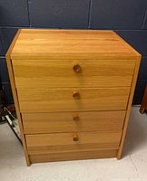Front view of 4-drawer wood unit