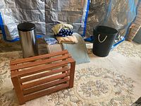 Group showing garbage can, shoe rack, laundry basket, ironing board, mats, towels