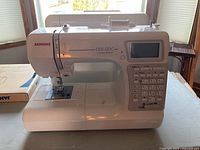 Front view of Janome 5200 QDC sewing machine showing control panel and needle area