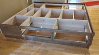 Overview of wooden king platform bed frame showing drawer compartments