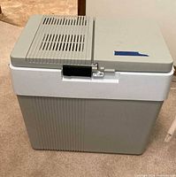 Closed cooler showing exterior condition, grey body, white band, ventilation slots on lid