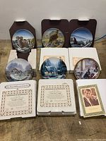 All six plates upright on stands with boxes, COAs visible