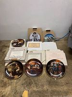 All six plates, boxes and paperwork laid out