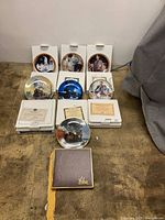 All six plates displayed with their boxes and COAs