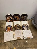 Six plates, three in plaques, boxes and COAs visible