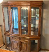 Full front view of two-piece oak china cabinet