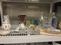 Full lot on shelf showing all glassware and ceramics