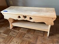 Small pine bench with heart cutouts and lower shelf