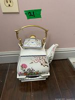 Teapot on stand showing overall design and handle