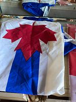 loose blue and white banner with red maple leaf