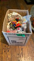 Overall view of box filled with bagged and loose Happy Meal toys