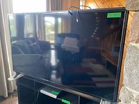 Front view of Philips 65-inch TV on stand