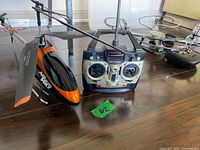 Helicopter side view with transmitter and other items nearby