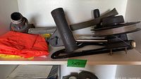 Downrigger parts on shelf: rod holder, boom arm, red pouch