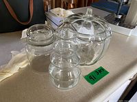 Three clear glass jars with lids displayed together