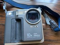 Front view of Sony MVC-FD7 camera with lens and 10x zoom marking visible