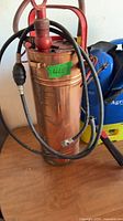 Copper sprayer front view with hose and handle