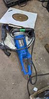 Concrete saw with power cord and attached blade