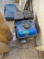 Overall view of blue Powerfist engine with fuel tank and pull starter