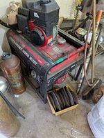 Generator full view showing frame, engine, fuel tank, nearby items