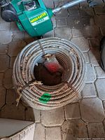 Full view of coiled armored cable on floor