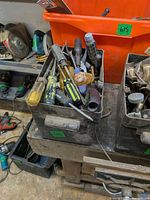 Top view of bin filled with assorted hand tools