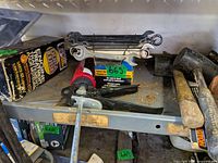 Shelf view with wrench set, caulking gun, boxed spray gun, mallets, hammer and pry bar