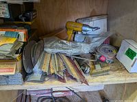 Shelf with pneumatic shear, collated fasteners, abrasive discs, welding rods