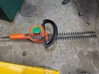 Full view of hedge trimmer showing body, handle and blade