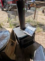 Overall view of stove with flue pipe and manual on top