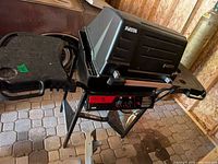 Full view of Fiesta Classic 315 grill with lid closed and side shelves attached