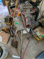 Overall view showing vise on stand with cord reel and shovel