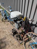 Full view of Johnson outboard motor mounted on stand with cables and extra parts below