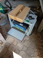 Top view of King Canada 12.5-inch thickness planer with cardboard piece on top