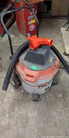 Full view of RIDGID wet/dry vacuum with hose and nozzles