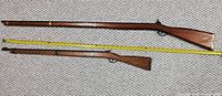 Both toy rifles side by side with measuring tape showing 51" and 37" lengths